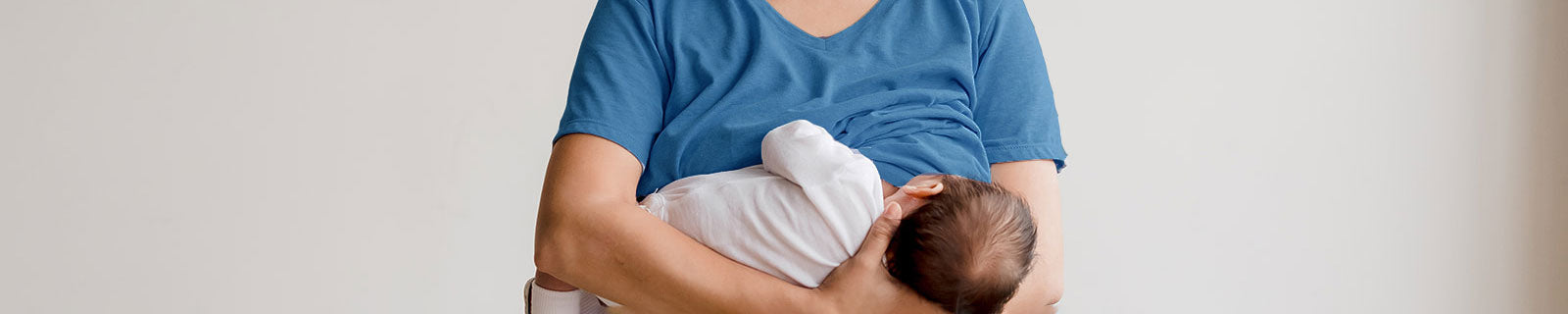 mother wearing blue nursing tee with baby