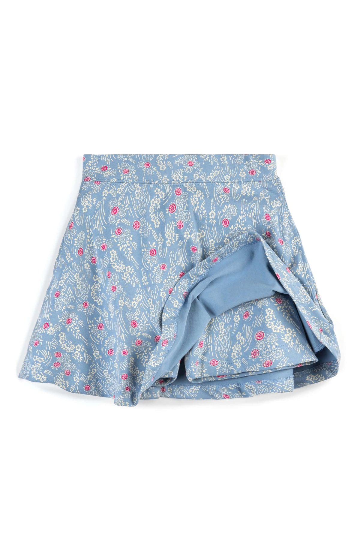 A light blue skort with a delicate white floral pattern and small pink accents, shown flat against a white background.