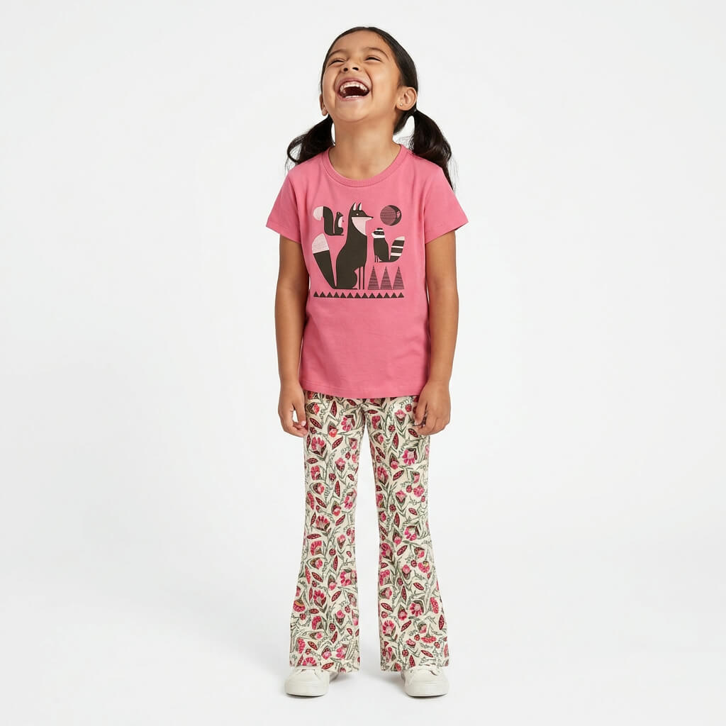 Young girl wearing a Mightly 100% organic cotton graphic tee with a graphic fox print and floral print pants.