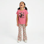 Young girl wearing a Mightly 100% organic cotton graphic tee with a graphic fox print and floral print pants.