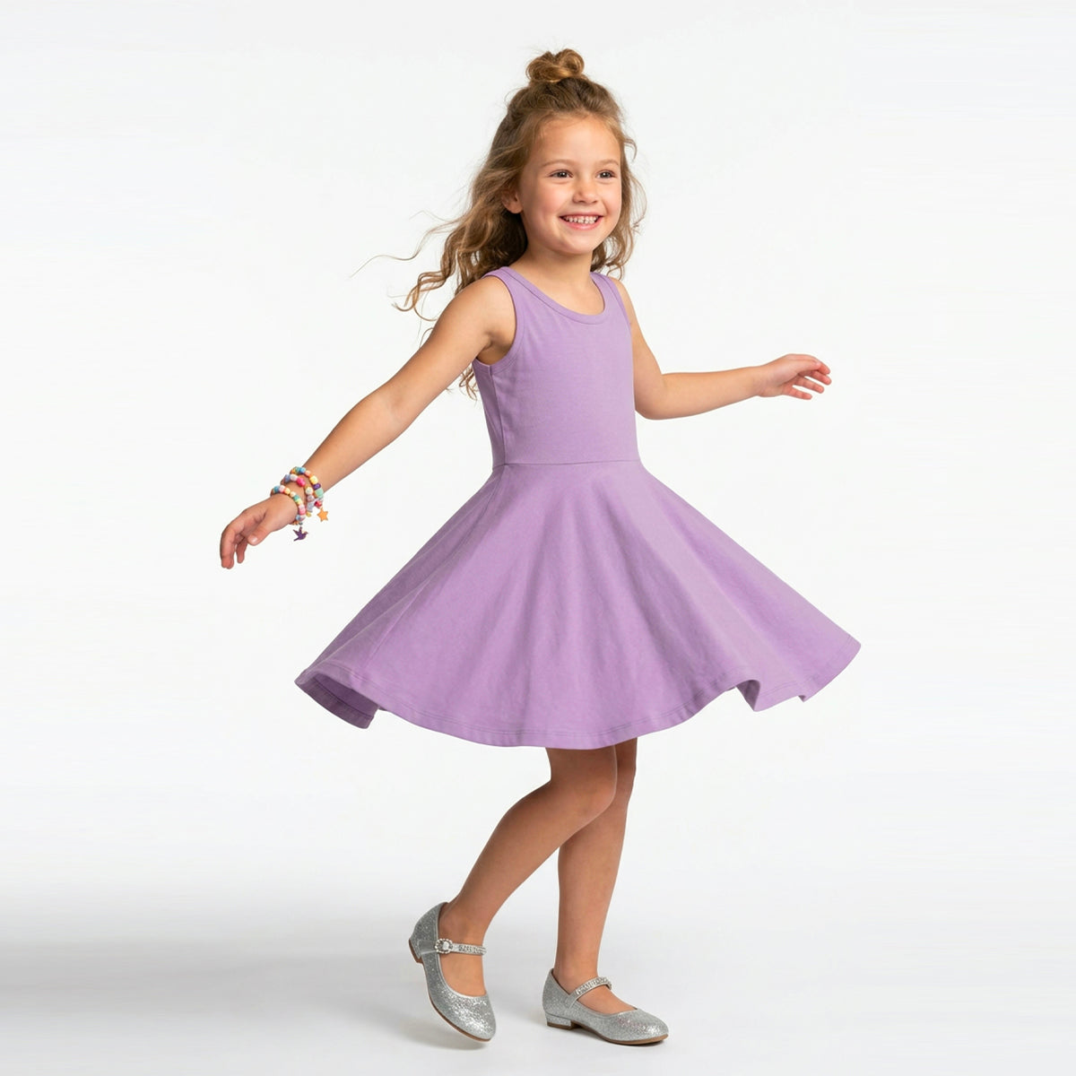 Young girl wearing a purple dress on a white background