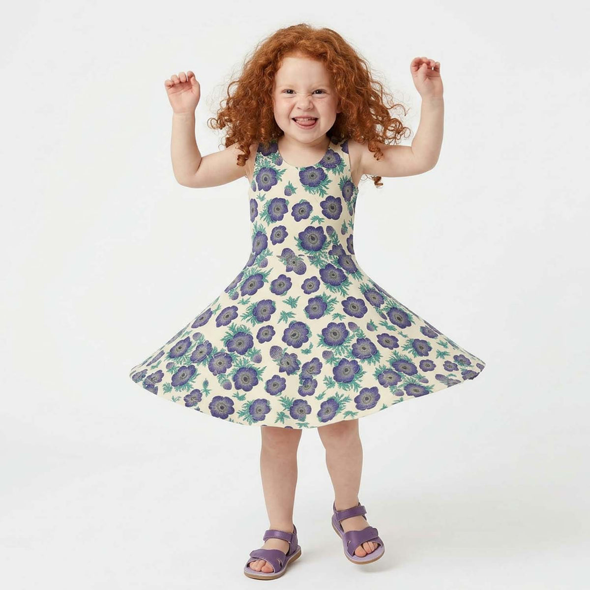 Young girl wearing a purple floral dress on a white background