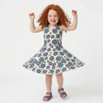 Young girl wearing a purple floral dress on a white background