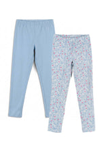 Two pairs of children's leggings laid flat on a white background. The left pair is solid light blue, and the right pair is a light blue base with a small pink and white floral pattern.