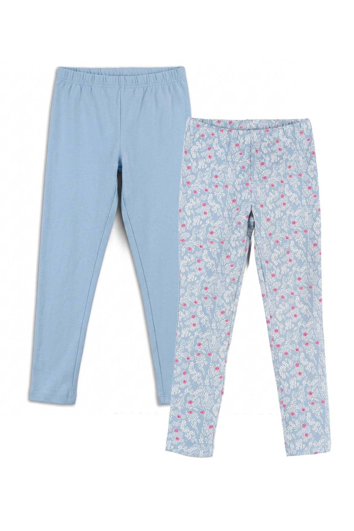Two pairs of children's leggings laid flat on a white background. The left pair is solid light blue, and the right pair is a light blue base with a small pink and white floral pattern.