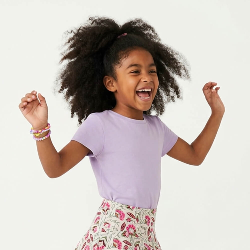 Child wearing a purple shirt and floral skirt on a white background