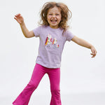Child wearing a purple shirt with a colorful bird design and pink pants on a white background