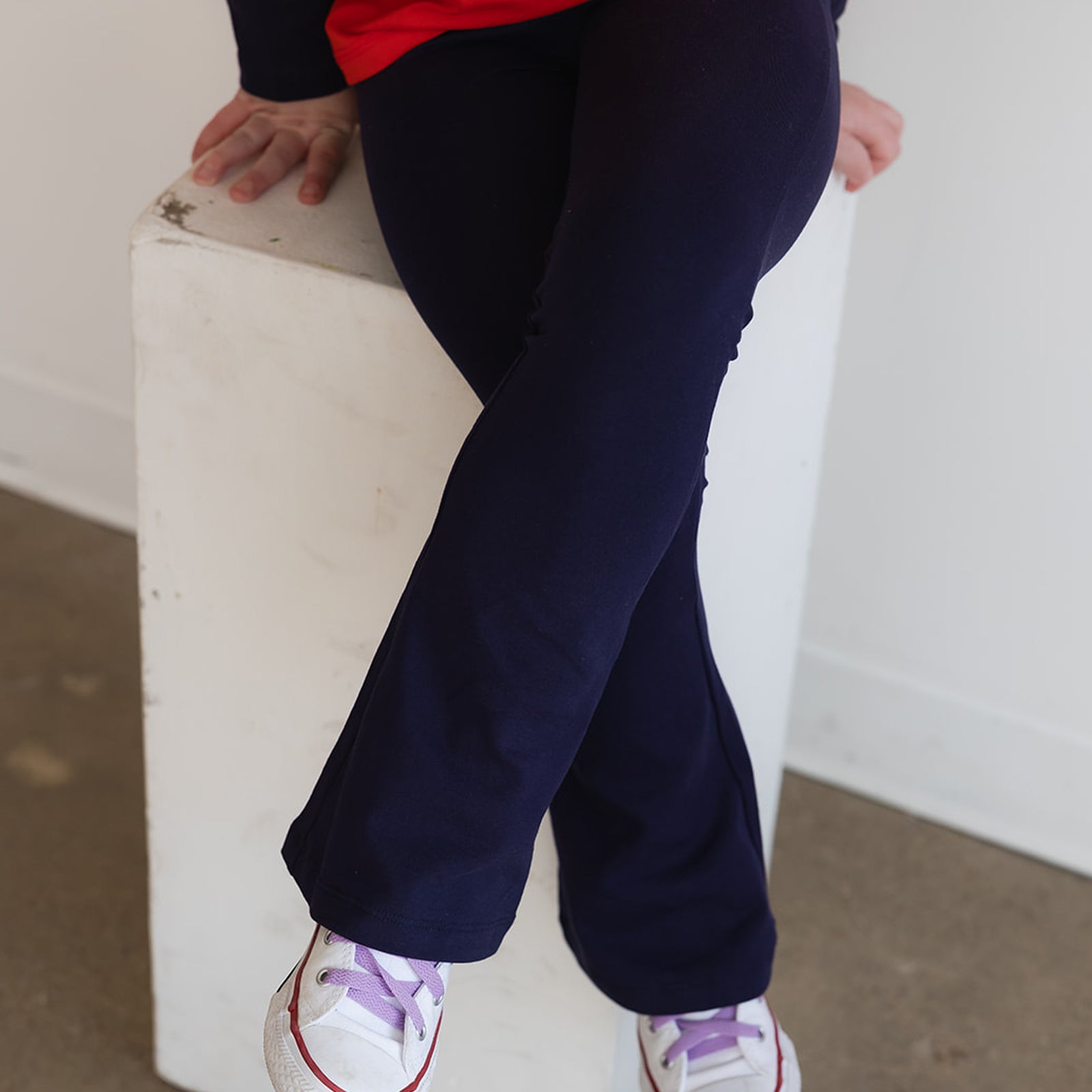 close up of a child wearing navy blue yoga pants