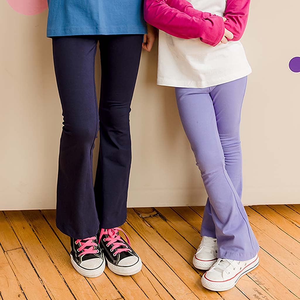 close of two kids wearing flared yoga pants. One pair is navy blue and one is light purple